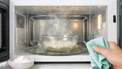 How to clean greasy microwave splatters fast with steam and baking soda